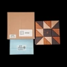 Karakuri Box: Ninja – Aerial view of the Karakuri box, its scuffed gift box and the opened solution envelope – By Osamu Kasho