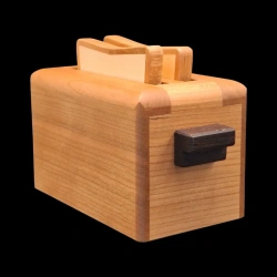 Karakuri Box : The Toaster (small) - Vue de face en diagonale - Poignée en bois marron foncé - Idée A. Kamei - KCG