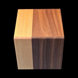 Himitsu-bako: Cube 3 Sun 18 Steps – Top view of two two-tone sides (brown and yellow) – Designer: Hiroyuki Oka